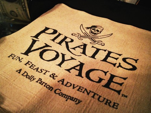 A burlap napkin featuring the logo for "Pirates Voyage," a fun dining experience by Dolly Parton.