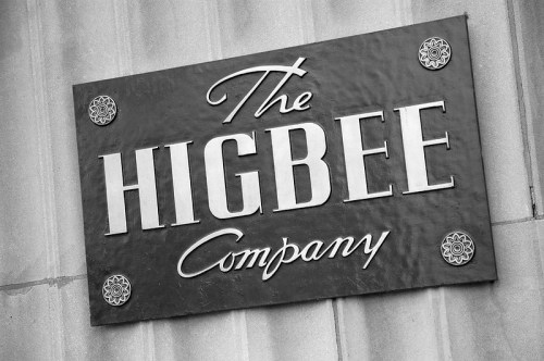 Sign for "The Higbee Company" in a classic font, displayed in black and white.