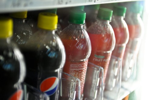 A close-up of a vending machine displaying various colorful beverage bottles.