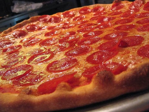 A close-up of a pepperoni pizza with a golden crust and melted cheese, fresh out of the oven.