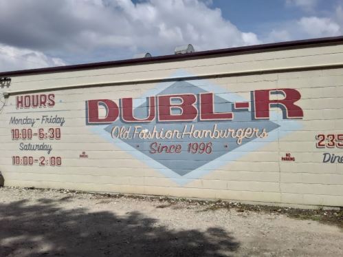 Mural on a wall featuring "DUBL-R Old Fashion Hamburgers" with hours of operation and establishment date since 1996.