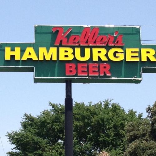 Sign for Keller's Hamburger Beer, featuring bold yellow and red letters against a green background.