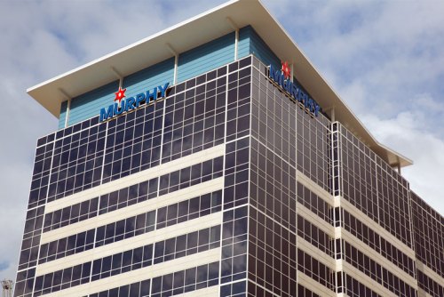 Modern office building with large glass windows and a sign that reads "MURPHY" on the top.