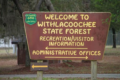Sign welcoming visitors to Withlacoochee State Forest, featuring directions to recreation information and administrative offices.