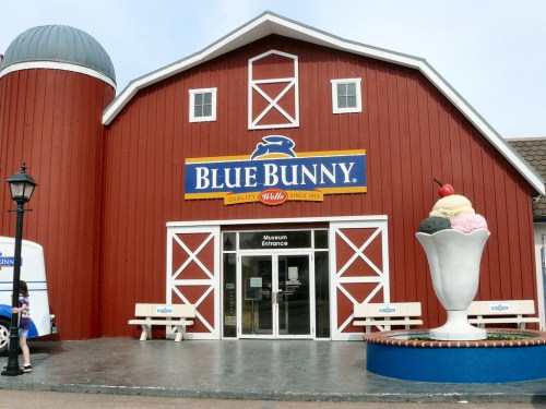 Red barn-style building with "Blue Bunny" sign, featuring a large ice cream sundae sculpture in front.