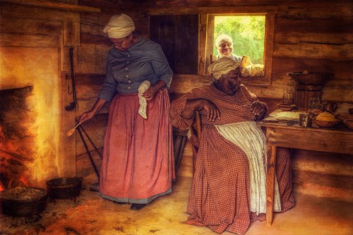 Two women in historical attire cook by a fire in a rustic cabin, while a third woman looks out from a window.