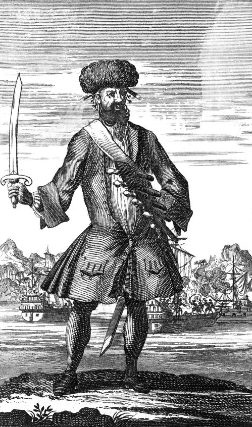 An 18th-century illustration of a pirate holding a sword, wearing a fur hat and elaborate clothing, with ships in the background.