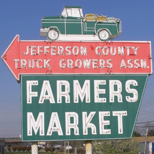 Sign for Jefferson County Truck Growers Association Farmers Market, featuring a vintage truck graphic and colorful text.