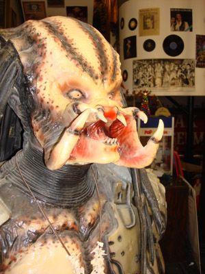 A detailed close-up of a Predator costume, showcasing its fierce facial features and intricate design.