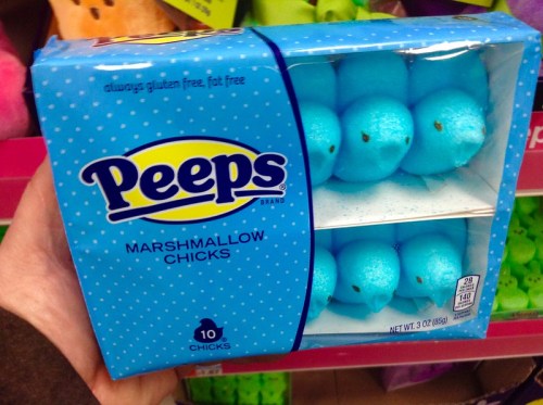 A hand holding a blue box of Peeps marshmallow chicks, containing 10 gluten-free and fat-free treats.