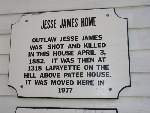Sign marking the Jesse James Home, noting he was shot here on April 3, 1882, and moved to this location in 1977.