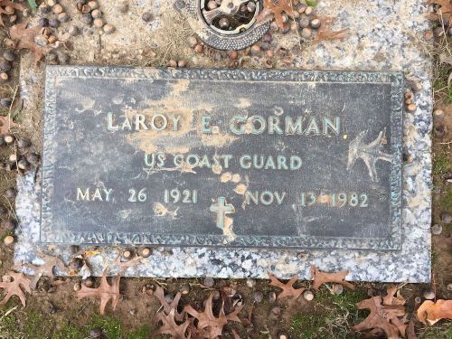 Gravestone of LaRoy E. Gorman, US Coast Guard, born May 26, 1921, died November 13, 1982, surrounded by fallen leaves.