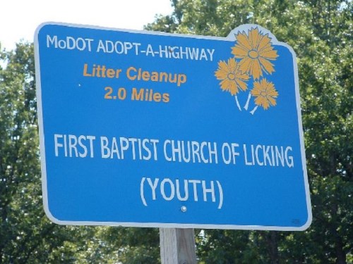 Blue sign for MoDOT Adopt-A-Highway program, indicating litter cleanup by First Baptist Church of Licking (Youth) for 2 miles.