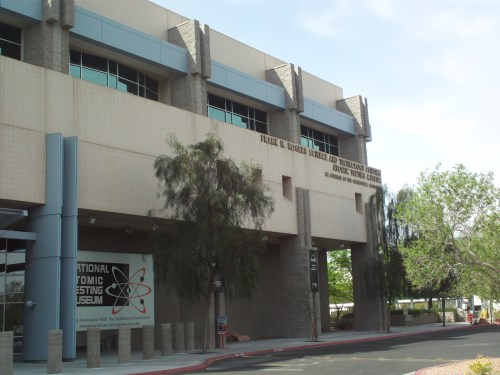 Exterior view of the National Atomic Testing Museum, featuring a modern building with large windows and signage.