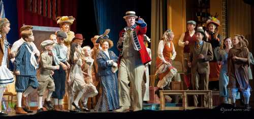 A lively theater scene with a diverse cast in period costumes performing on stage, showcasing a vibrant musical number.