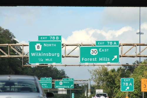 Highway exit signs for Wilkinsburg and Forest Hills, with clear directions and distances visible.