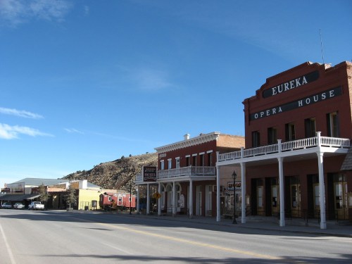 Historic buildings line a quiet street in Eureka, featuring the prominent Eureka Opera House under a clear blue sky.