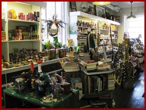 A cozy shop filled with shelves of canned goods, books, and various colorful items, creating a warm, inviting atmosphere.
