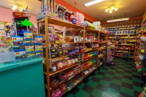 A colorful candy store interior with shelves filled with various sweets and snacks, featuring a checkered floor.