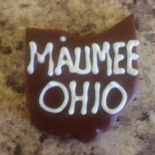 Chocolate treat shaped like the state of Ohio, with "Maumee Ohio" written in white icing.