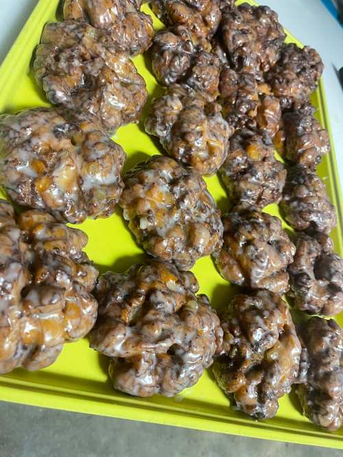 A tray of glazed, chocolate-covered pastries arranged neatly.
