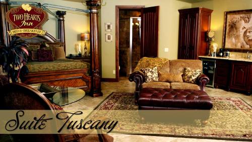 Luxurious suite with a plush sofa, elegant decor, and a warm color palette, featuring a four-poster bed and inviting ambiance.