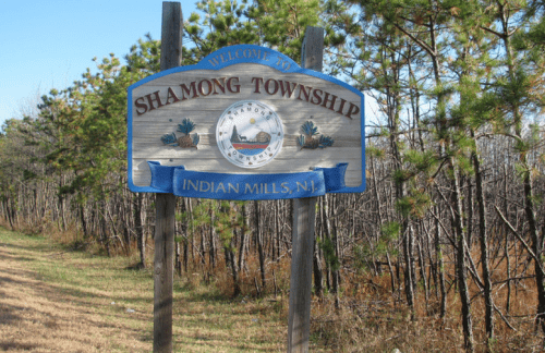 Welcome sign for Shamong Township, Indian Mills, NJ, surrounded by trees and natural scenery.