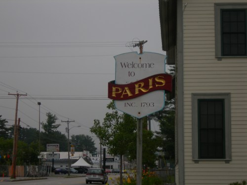 Sign welcoming visitors to Paris, established in 1793, with a cloudy sky in the background.