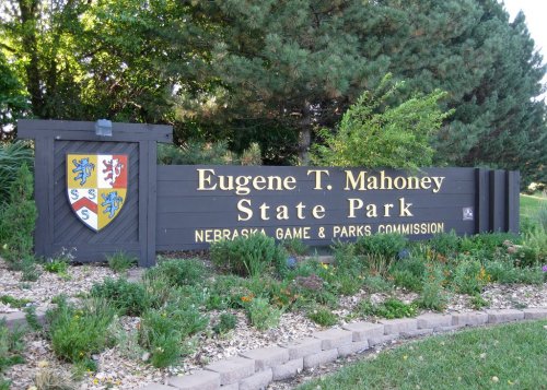 Sign for Eugene T. Mahoney State Park, featuring the park's name and the Nebraska Game & Parks Commission logo.