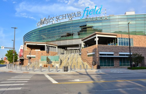 Exterior view of Charles Schwab Field in Omaha, featuring modern architecture and a clear blue sky.