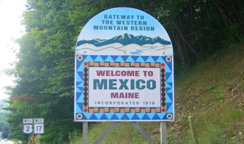 Sign welcoming visitors to Mexico, Maine, with a mountain backdrop and decorative border. Incorporated in 1818.
