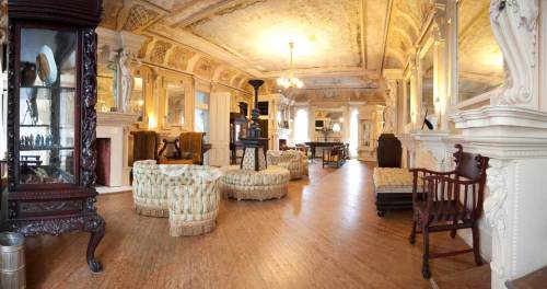 Elegant room with ornate ceilings, vintage furniture, and decorative mirrors, creating a classic, inviting atmosphere.