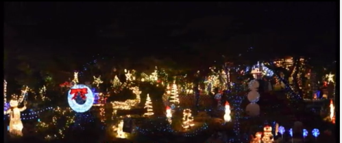A festive display of colorful Christmas lights and decorations illuminating a dark night.