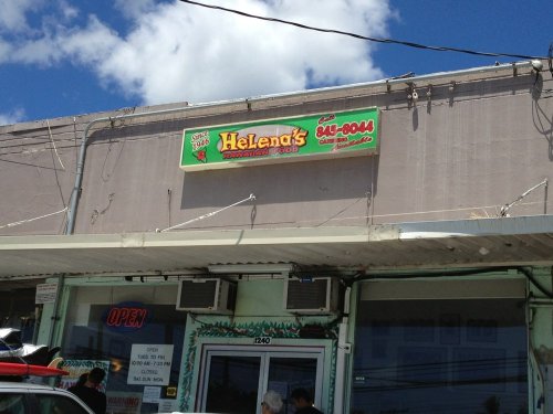 Sign for Helena's Restaurant with a bright green and red design, located on a storefront under a blue sky.