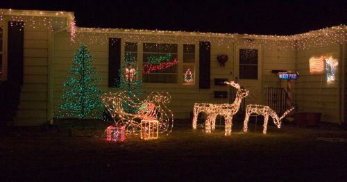 the front of a house in Iowa decorated with holiday lights for Christmas