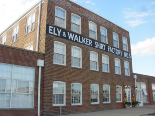 Brick building with large windows, featuring a sign that reads "Ely & Walker Shirt Factory No. 5."