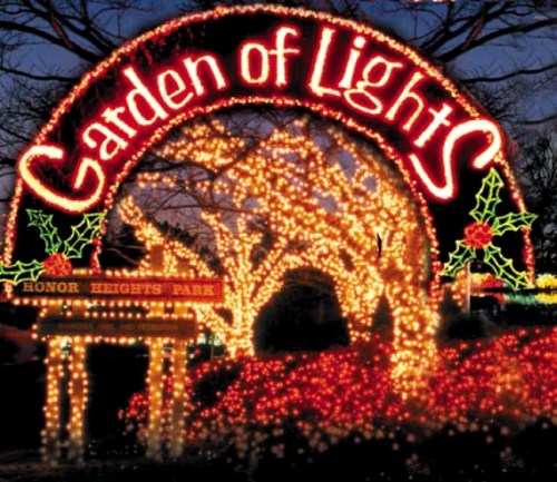 A festive archway reading "Garden of Lights" adorned with colorful holiday lights at Honor Heights Park.