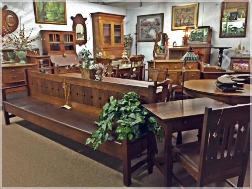 A cozy antique shop filled with wooden furniture, including benches, tables, and decorative items.