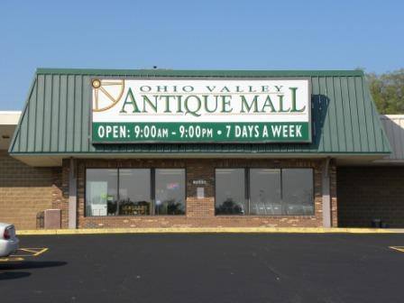 Exterior of Ohio Valley Antique Mall with a green roof and large sign, open daily from 9 AM to 9 PM.