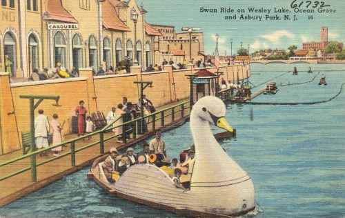 A vintage postcard depicting a swan boat on a lake, with people enjoying the waterfront in Ocean Grove, NJ.