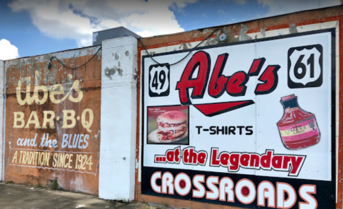 Mural featuring "Abe's Bar-B-Q and the Blues" and a sign for "Abe's T-Shirts" at the Legendary Crossroads.