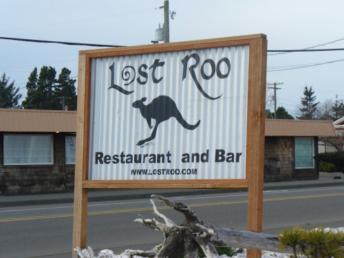 Sign for "Lost Roo Restaurant and Bar" featuring a kangaroo silhouette, set against a rustic background.