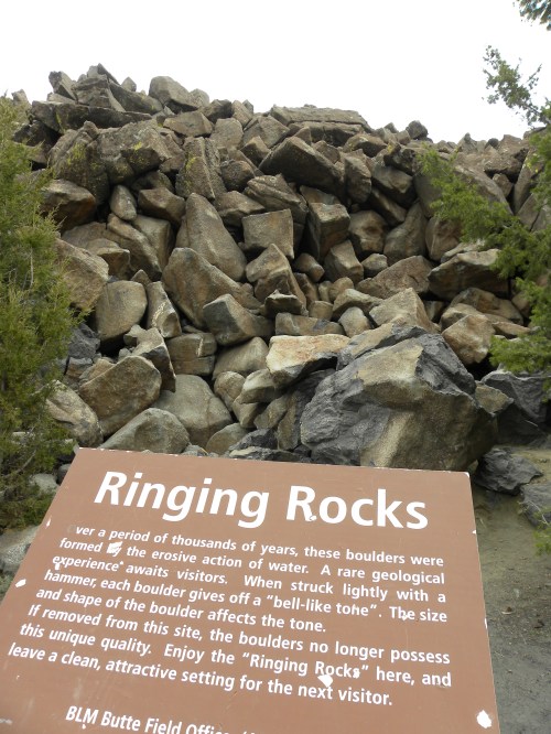 A large pile of boulders with a sign explaining the unique geological feature called "Ringing Rocks."