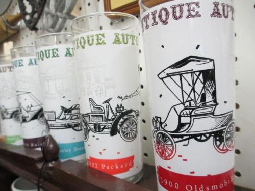 Colorful vintage glasses featuring illustrations of classic cars labeled "Antique Auto."