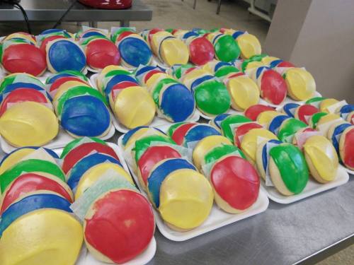 Colorful, round candies arranged on white trays, featuring red, blue, green, and yellow sections.
