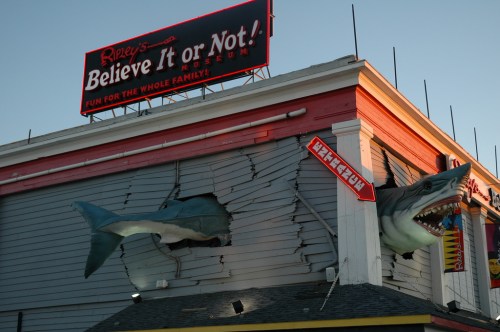 A building with a sign for Ripley's Believe It or Not! featuring a shark bursting through the wall.