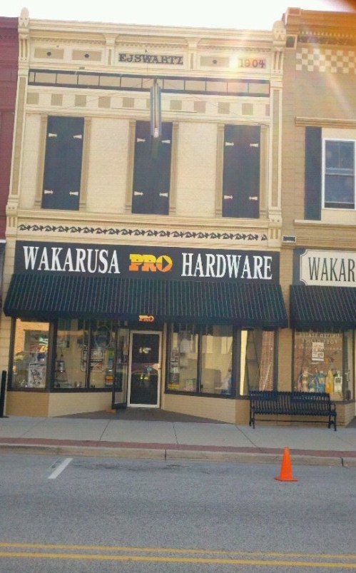 Front view of Wakarusa Pro Hardware store, featuring large windows and a classic architectural design.
