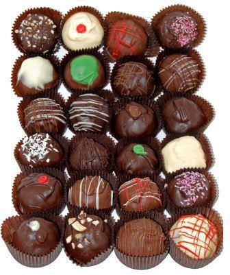 A variety of chocolate truffles arranged in a grid, featuring different toppings and decorations.