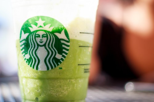 A close-up of a green beverage in a Starbucks cup, with the logo prominently displayed.