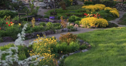A vibrant garden with colorful flowers, winding paths, and lush greenery, creating a serene outdoor space.